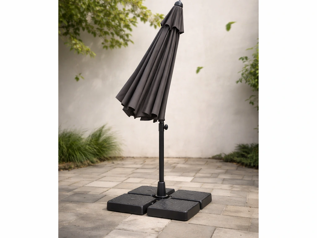 Outdoor solar umbrella with a heavy weighted cross-base/anchor clearly visible on a windy patio.